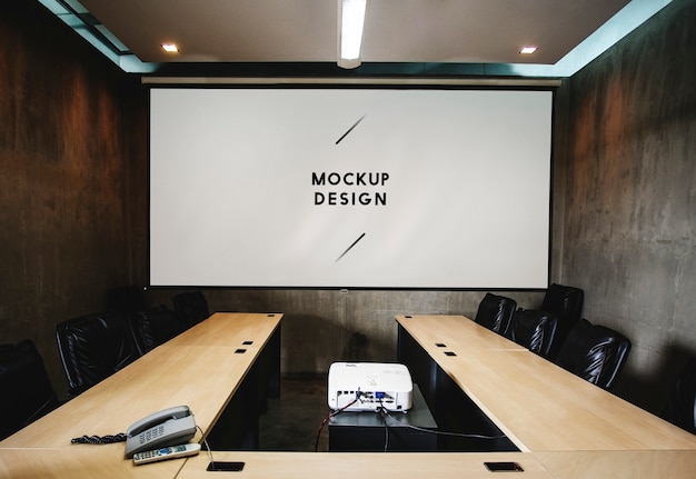 Blank white projector screen mockup in a meeting room