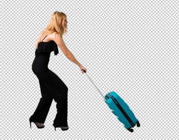 PSD blond girl traveling and pushing a suitcase that weighs a lot