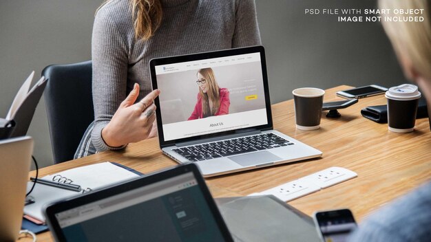 Blond woman pointing at a laptop screen