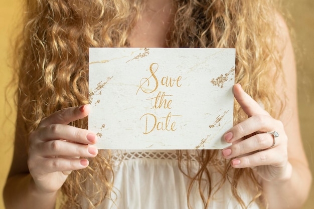 Blond woman with an invitation card mockup