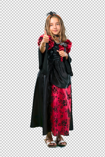 PSD blonde child dressed as a vampire for halloween holidays giving a thumbs up gesture and smiling