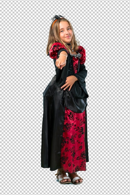 Blonde child dressed as a vampire for halloween holidays points finger at you