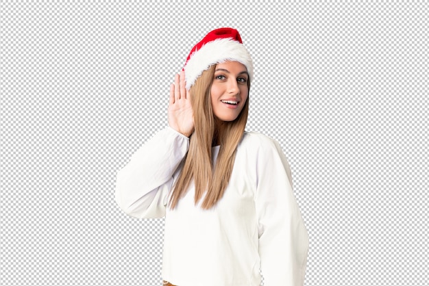 PSD ragazza bionda con il cappello di natale che ascolta qualcosa