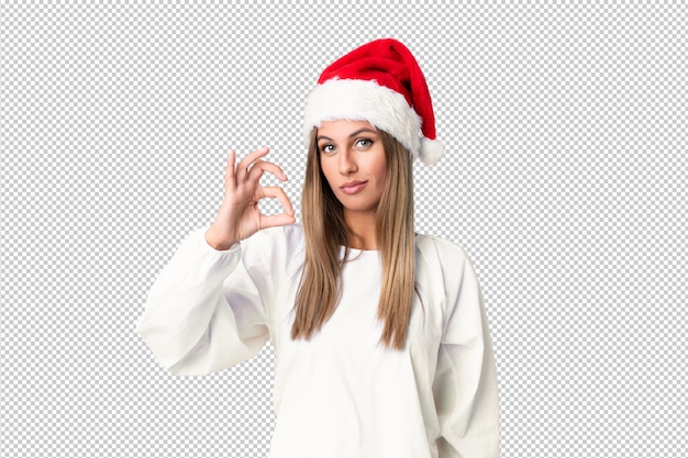 Blonde Girl with christmas hat showing an ok sign with fingers