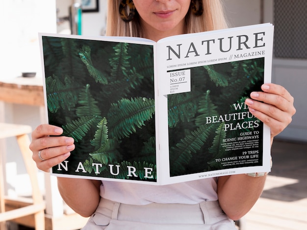 PSD blonde woman looking into a nature magazine mock up