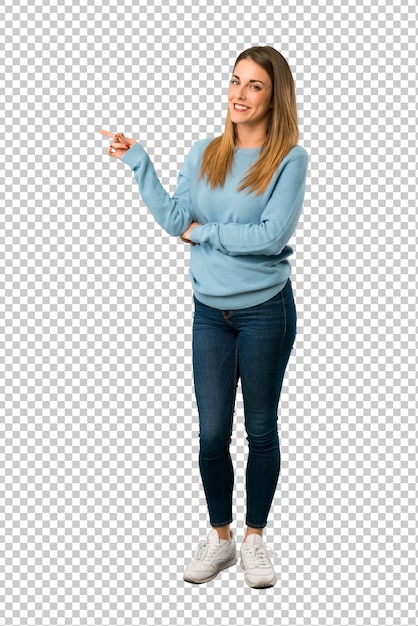 Blonde woman with blue shirt pointing finger to the side in lateral position