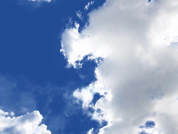a blue sky with clouds and a plane in the sky