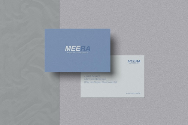 A blue and white business card that says meenaa.