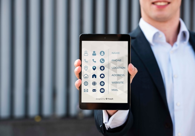 blurred man holding digital tablet outdoors