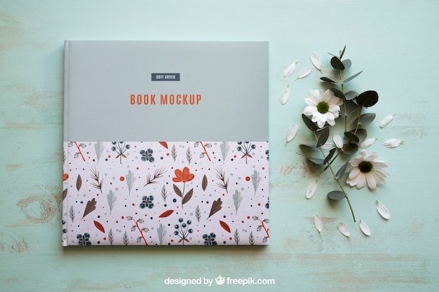 PSD book mockup next to flowers