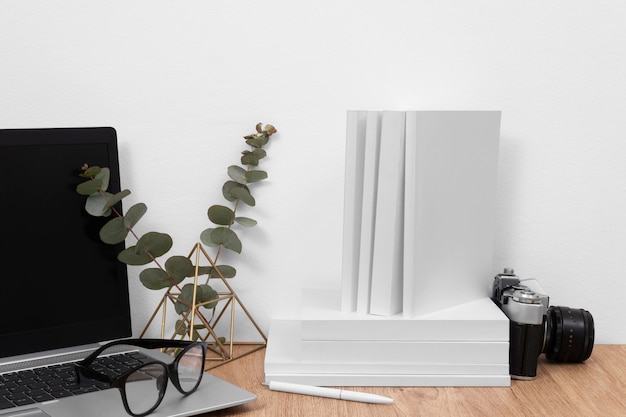 Books, laptop and camera arrangement