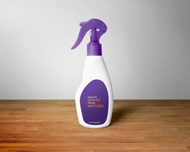 A bottle of purple spray cleaner on a wooden table.