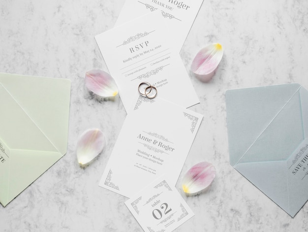 PSD bovenaanzicht van bruiloft kaarten met ringen en bloemblaadjes