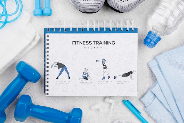 PSD bovenaanzicht van fitness notebook met sneakers en gewichten