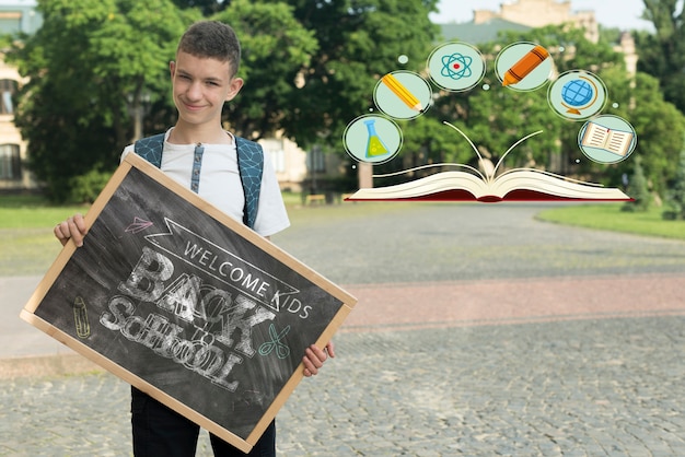 Boy holding a blackboard mock-up