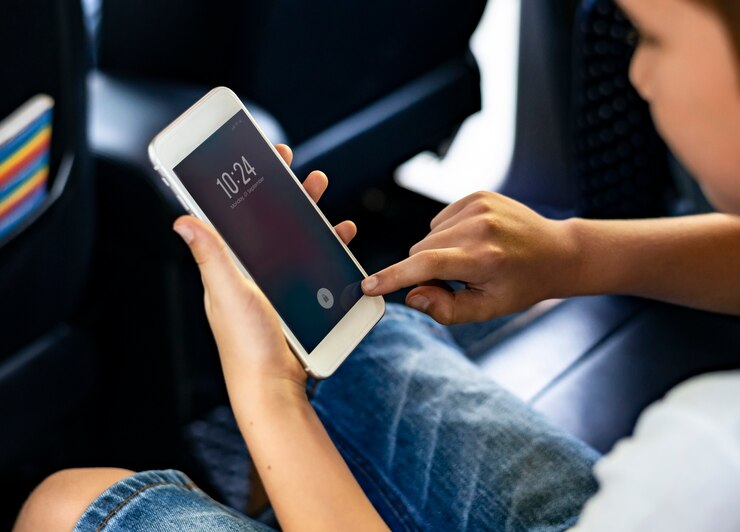 PSD boy playing on a smartphone in the car