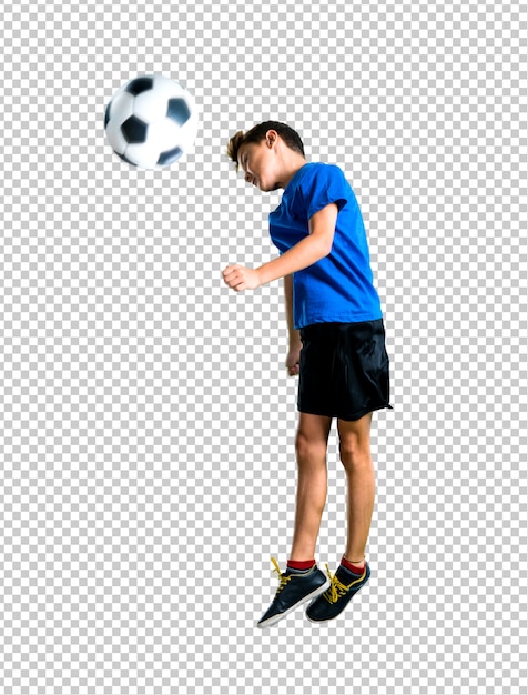 Boy playing soccer hitting the ball with the head