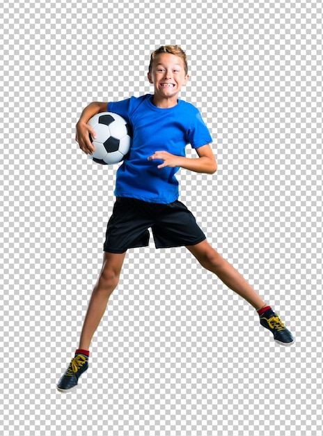 Boy playing soccer and jumping