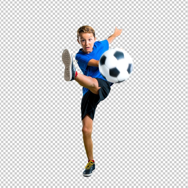 Boy playing soccer kicking the ball