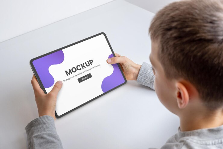 PSD boy at work deskwith tablet mockup for game or app promotion