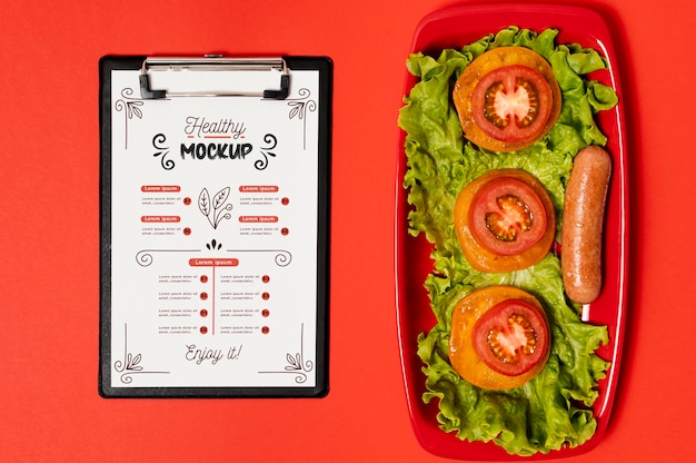 Breakfast with clipboard and slices of tomatoes