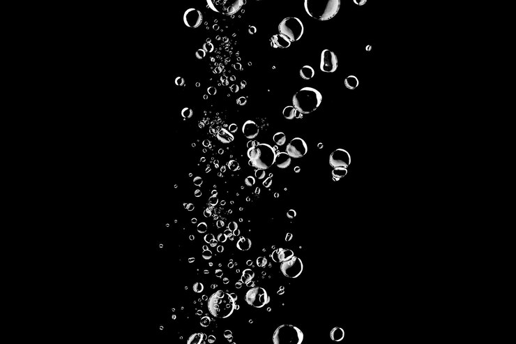 PSD bubbles rising in water against a black background