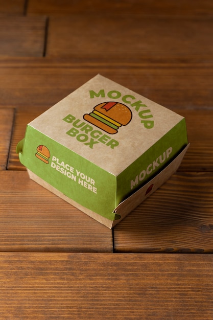 PSD burger box on wooden background high angle