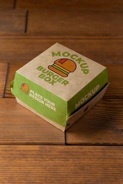 Burger box on wooden background high angle