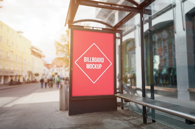 PSD bus stop billboard mockup. sun light and street