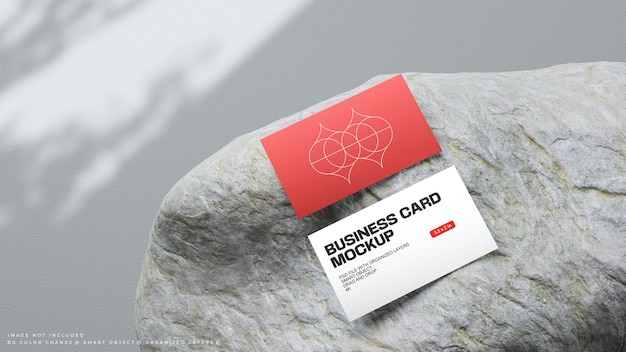 Business card mockup on mossy rock for branding presentation or showcase