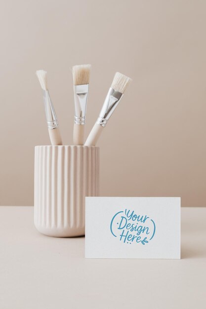 business card mockup with brushes and art supplies