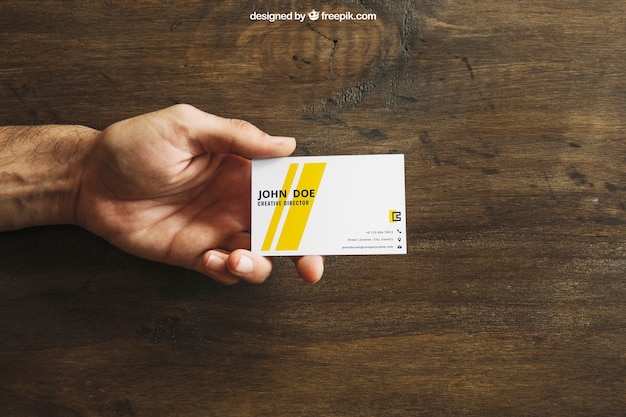 Business card mockup with hand