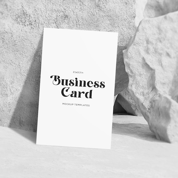 Business card mockup with vertical view leaning on stone background