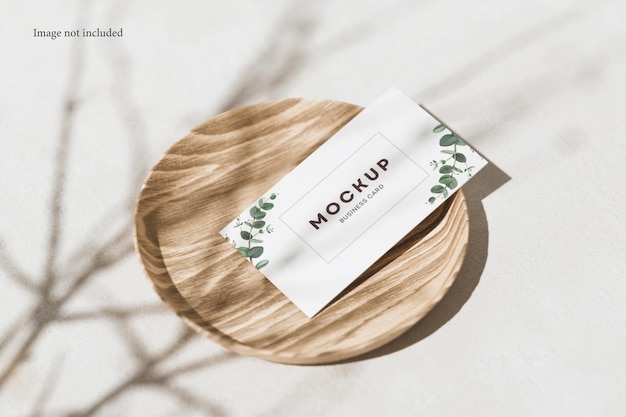 Business card mockup on wooden plate