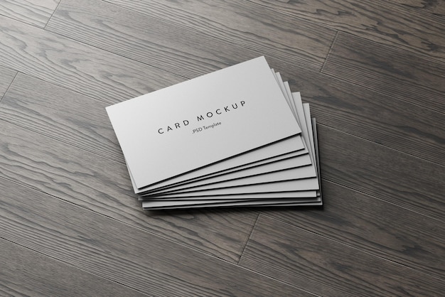 Business card stack on wooden background mockup