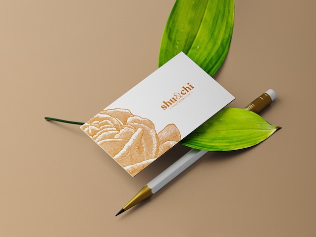 Business card on two leaves and a pencil mockup perspective view