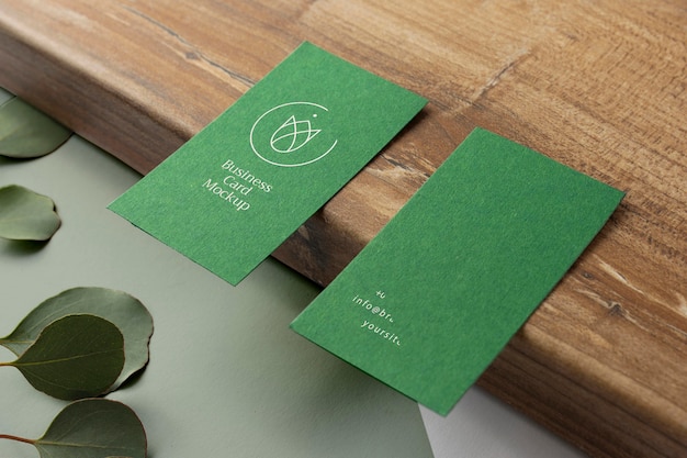 PSD business cards on wooden board high angle