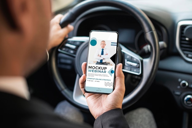 Business man in car with phone mockup