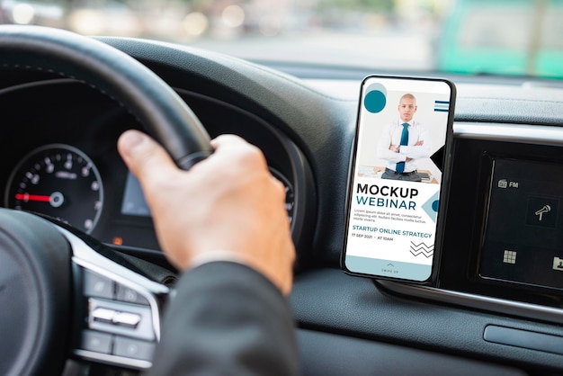 Business man in car with phone mockup