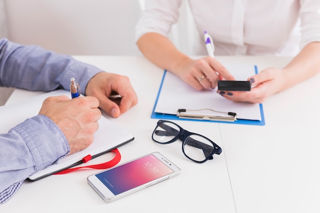 Business people writing on clipboard