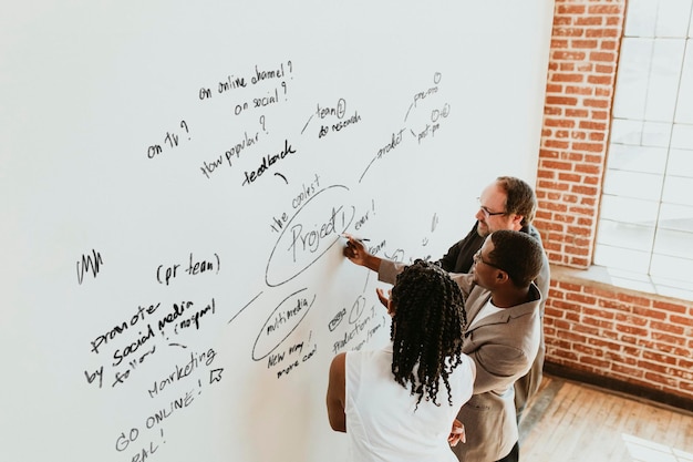 business people writing on a whiteboard mockup