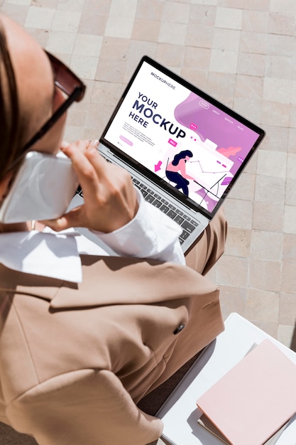 PSD business woman holding her laptop mock-up