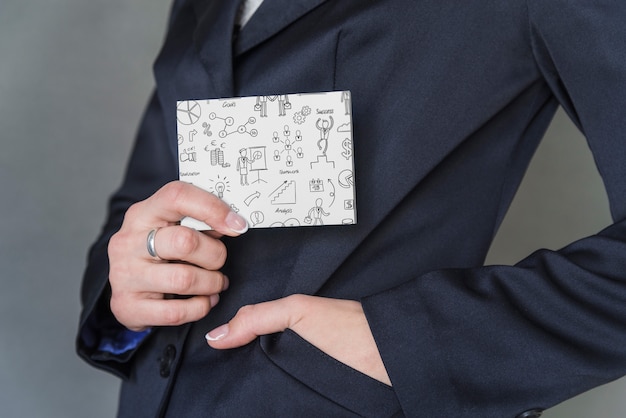 Businessman pulling notebook out of pocket