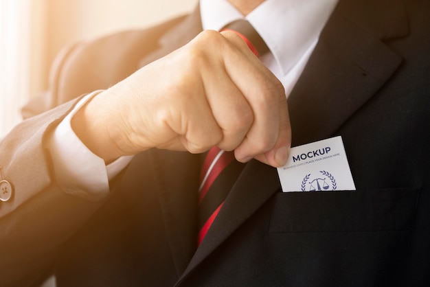 Businessman putting business card mock-up in his pocket