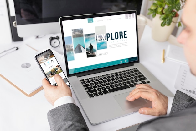 PSD businessman working at desk with mock-up laptop and phone