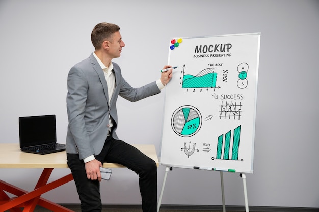 PSD businessperson presenting in a meeting on big white board mockup