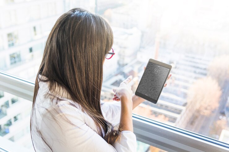 PSD businesswoman with tablet in front of city skyline