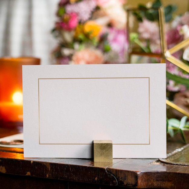 PSD card mockup by bouquet of flowers on a wooden table