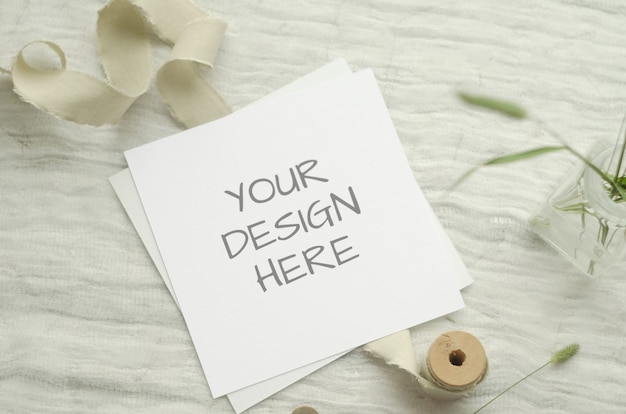 card mockup with herbs, vintage spool of cotton braid on a light background.