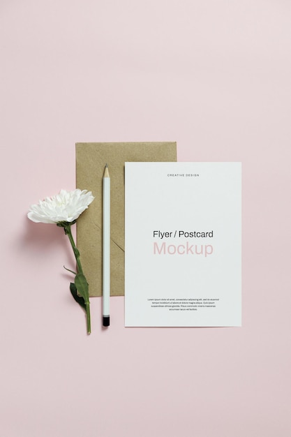 Card mockup with white flower stationery and golden paper clips